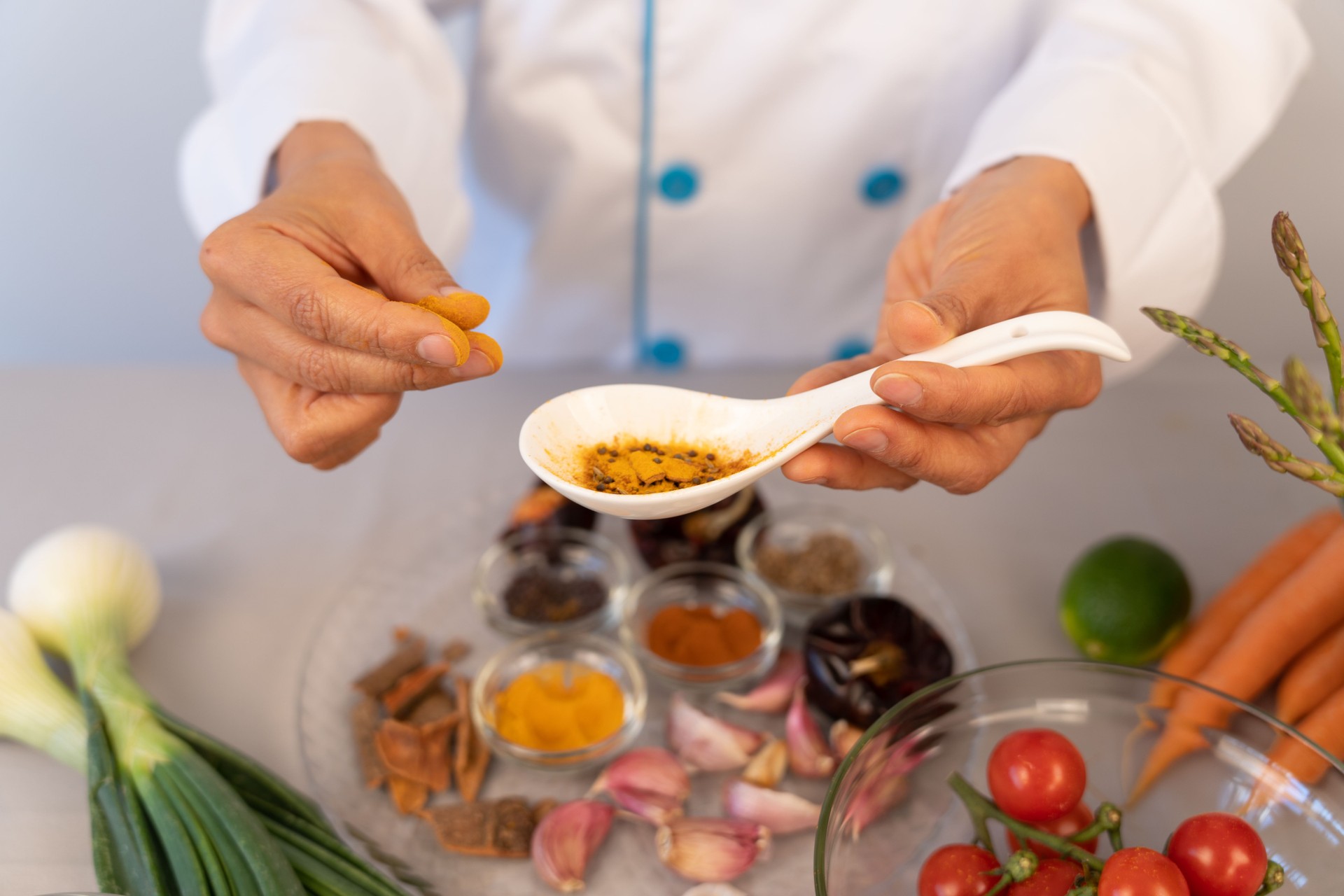 Beautiful close-up of chef hand in the kitchen manipulating color and textures of spices